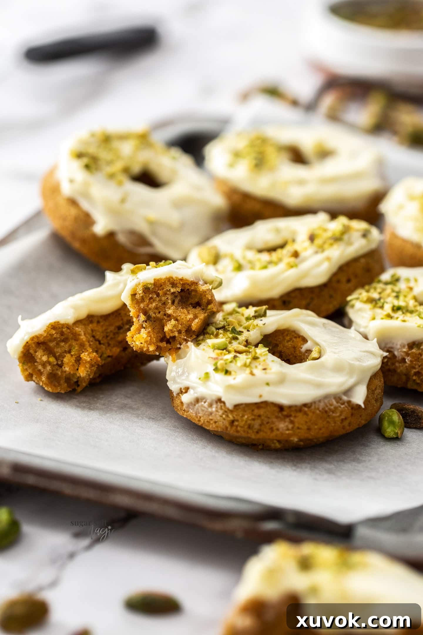 A carrot cake donut broken open to show the texture inside.