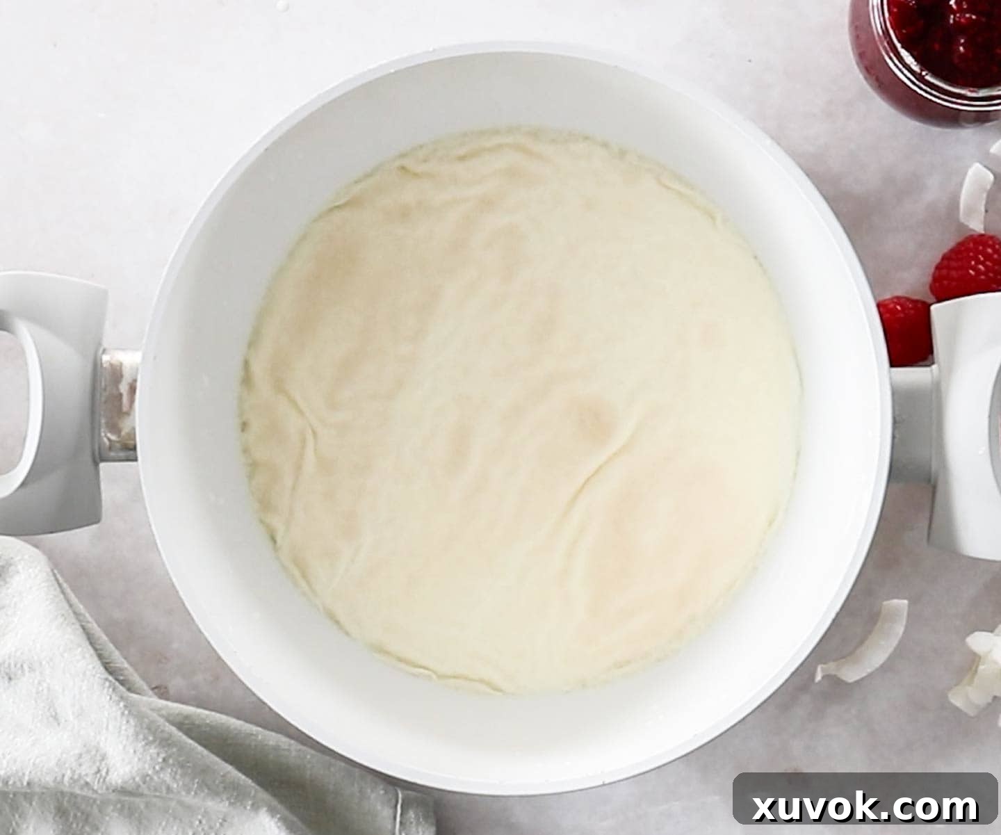 The gelatine blooming in the milk in a pan.
