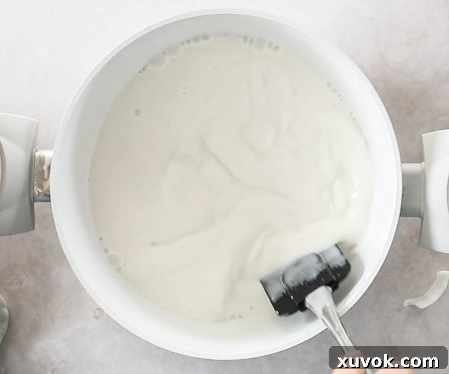 Adding the coconut milk to the gelatine mixture.