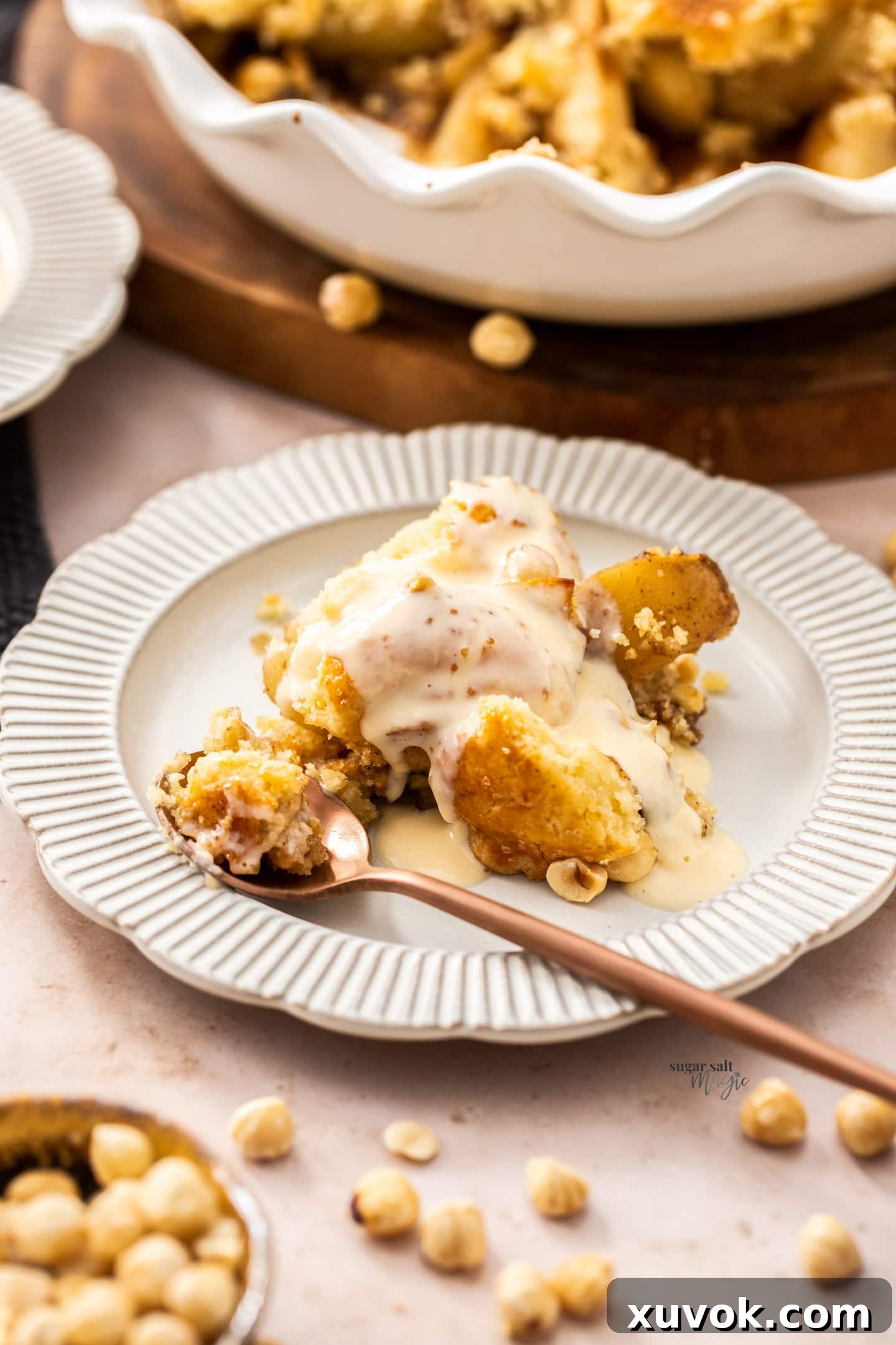 A close-up serving of pear cobbler with luscious custard drizzled generously over the top, emphasizing its delicious appeal.