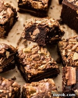 Top down view of a brownie on its side, showing its fudgy inside and crisp Kit Kat layers.