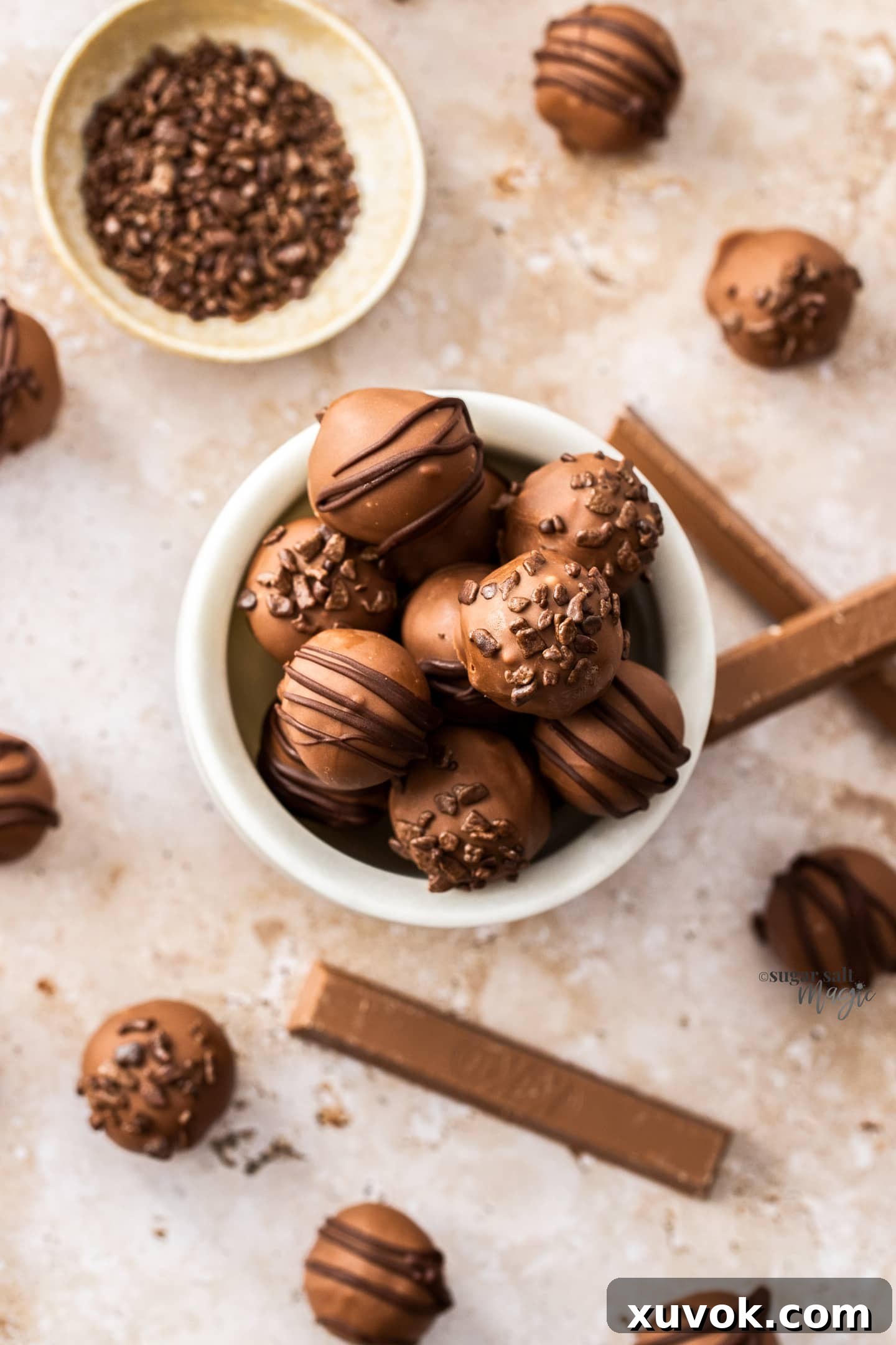 Top down view into a marble bowl filled with Kit Kat truffles.