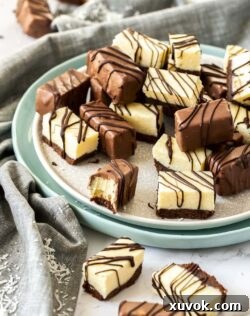 A plate full of pieces of fudge, some coated in chocolate