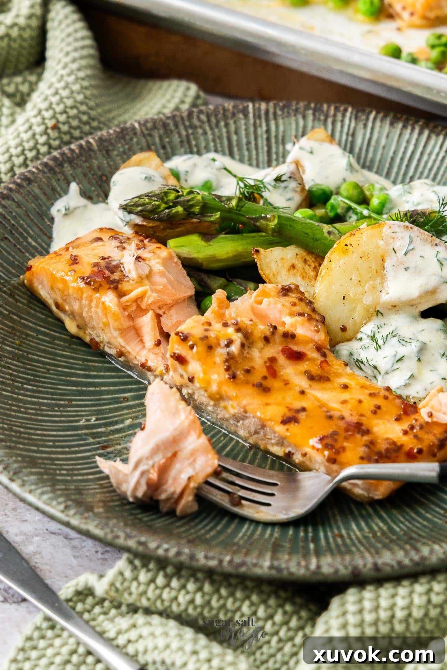 A salmon fillte on a dinner plate that's been cut open.