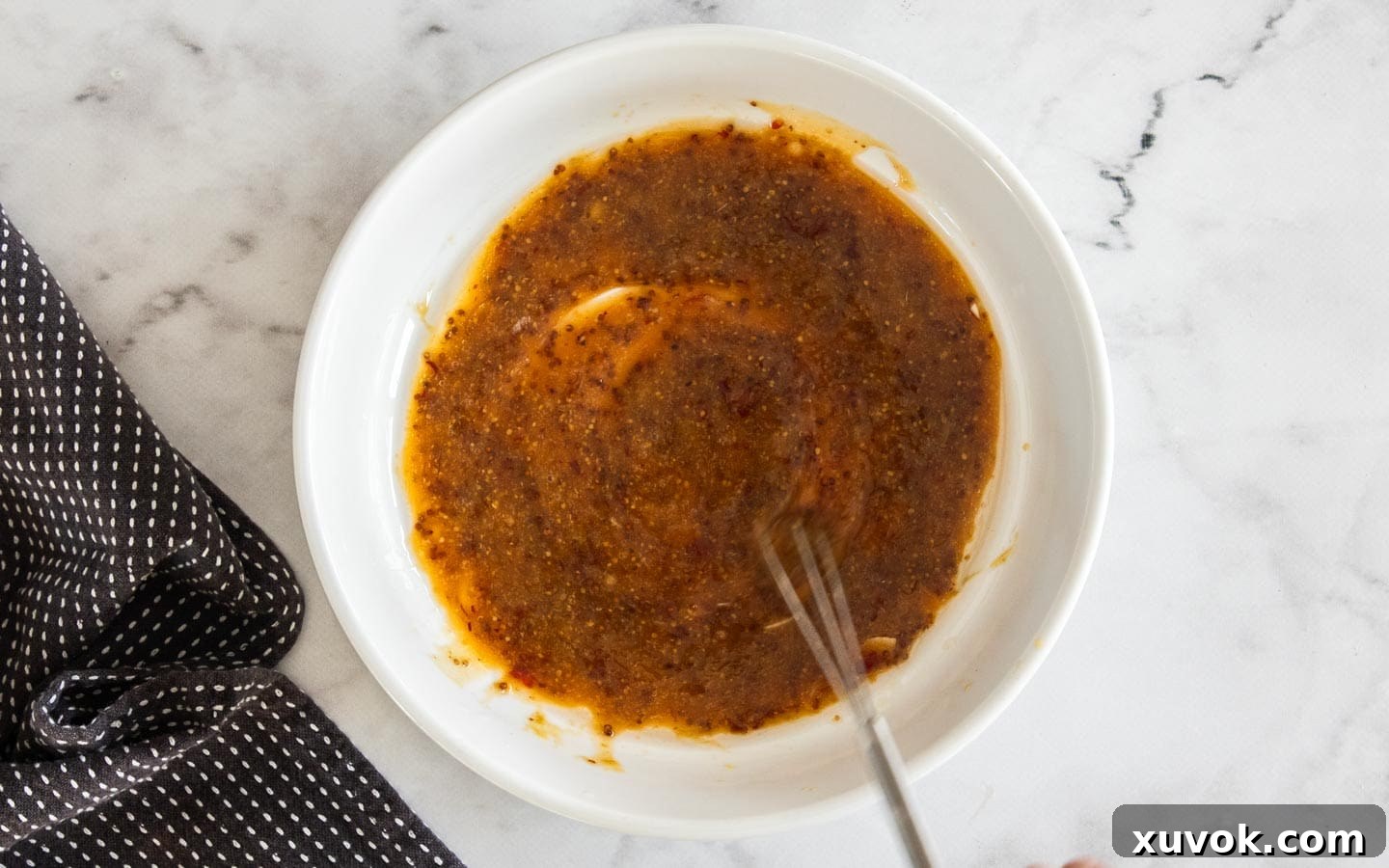 The marinade been whisked together in a bowl.
