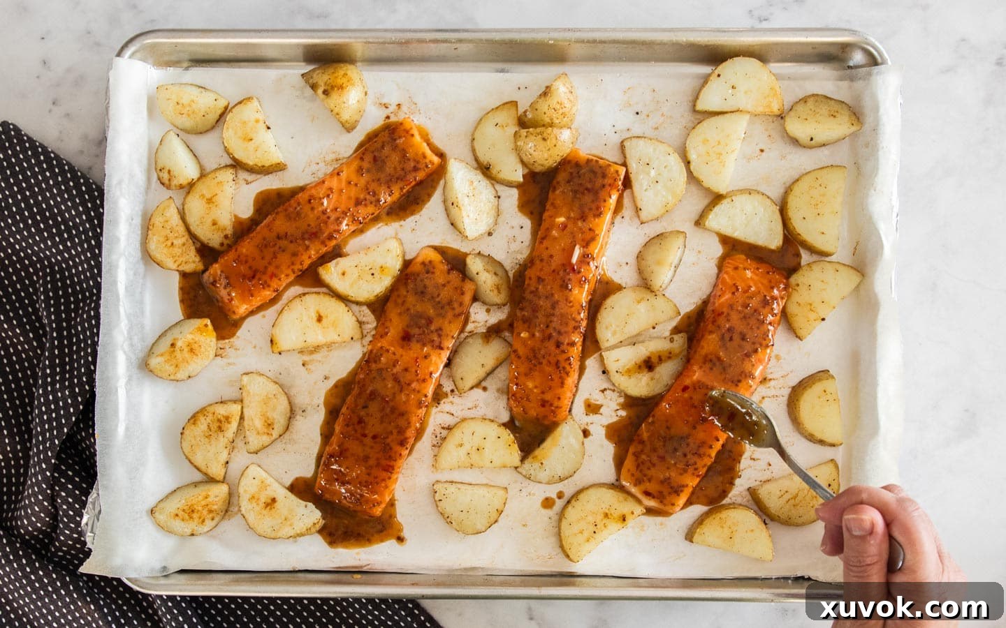 The salmon pieces added to the baking tray.