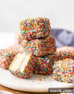 A stack of 3 fairy bread lamingtons.