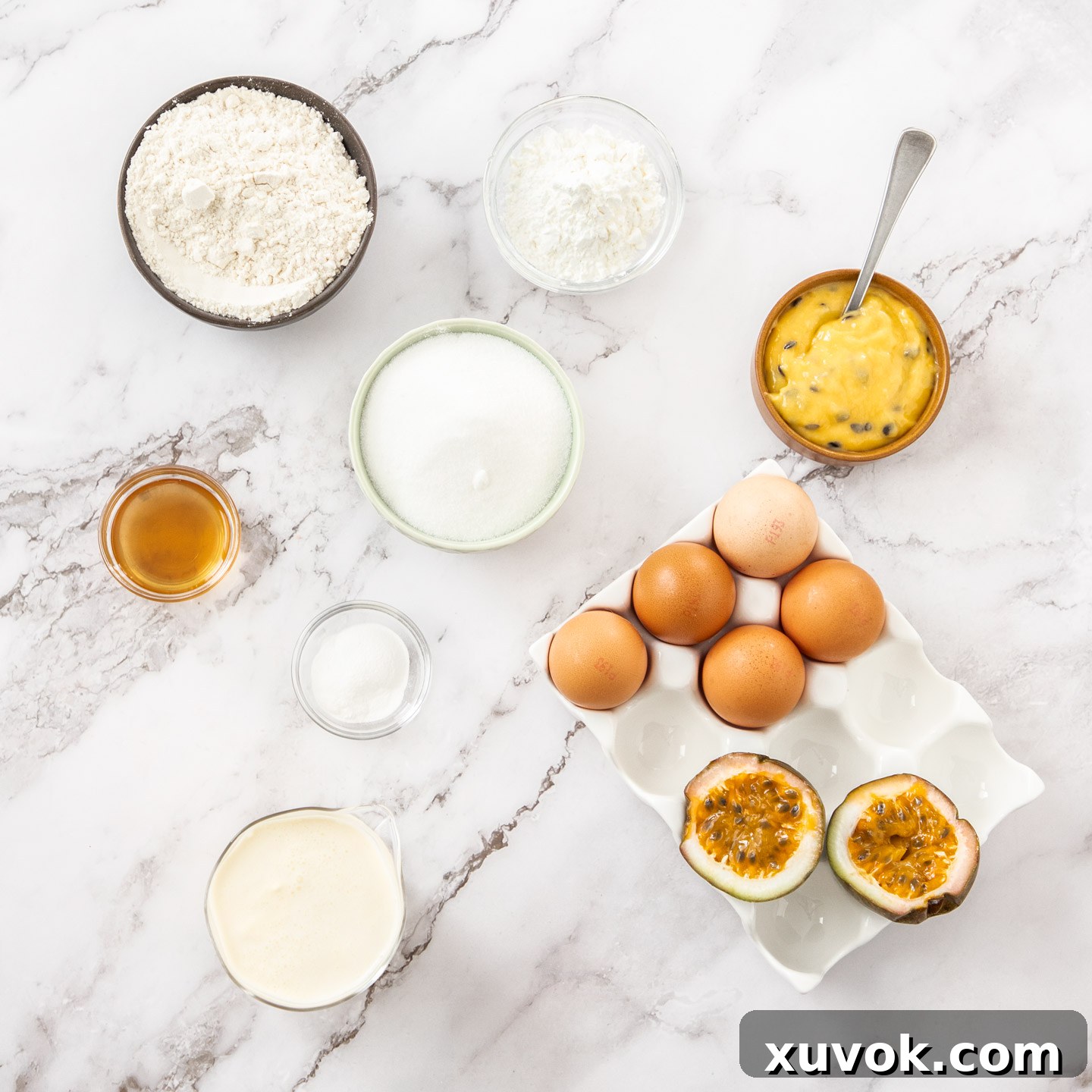 Ingredients for passionfruit sponge cake laid out on a marble surface.