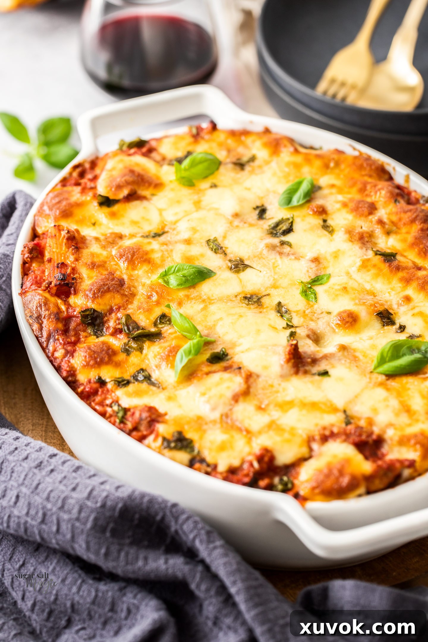 A casserole dish filled with baked rigatoni al forno, ready to be served, showing the perfectly browned cheese top.