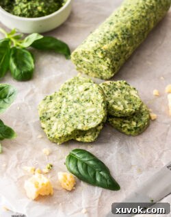 Disks of pesto butter on a sheet of baking paper.