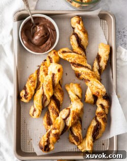 Top down view of a batch of Nutella twists with a small dish of Nutella.