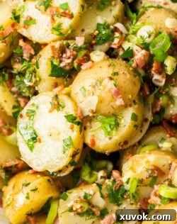 Extreme closeup of a vibrant no-mayo potato salad, highlighting its fresh ingredients and zesty dressing.