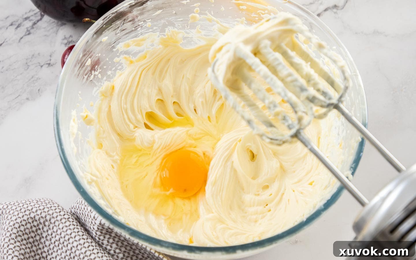 Egg added to the cheesecake mixture.
