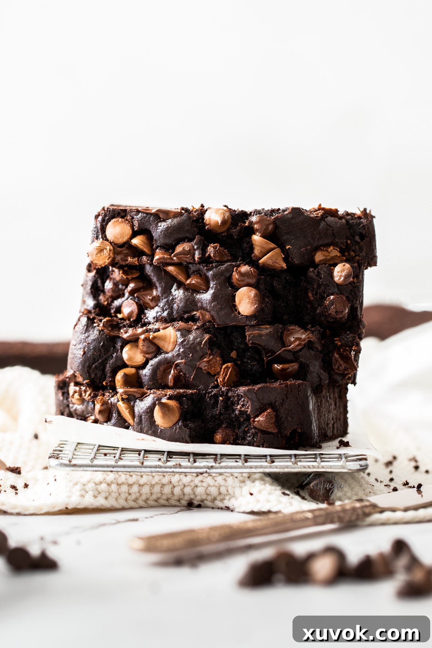 A beautiful stack of perfectly sliced chocolate zucchini cake, highlighting its rich color and tender texture, ready to be enjoyed.