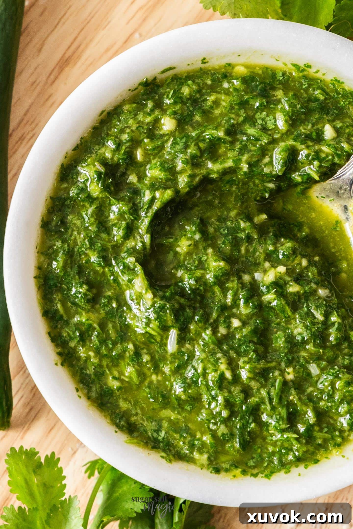 Closeup top down view of mojo verde in a marble bowl, showcasing its vibrant green color and fresh texture.