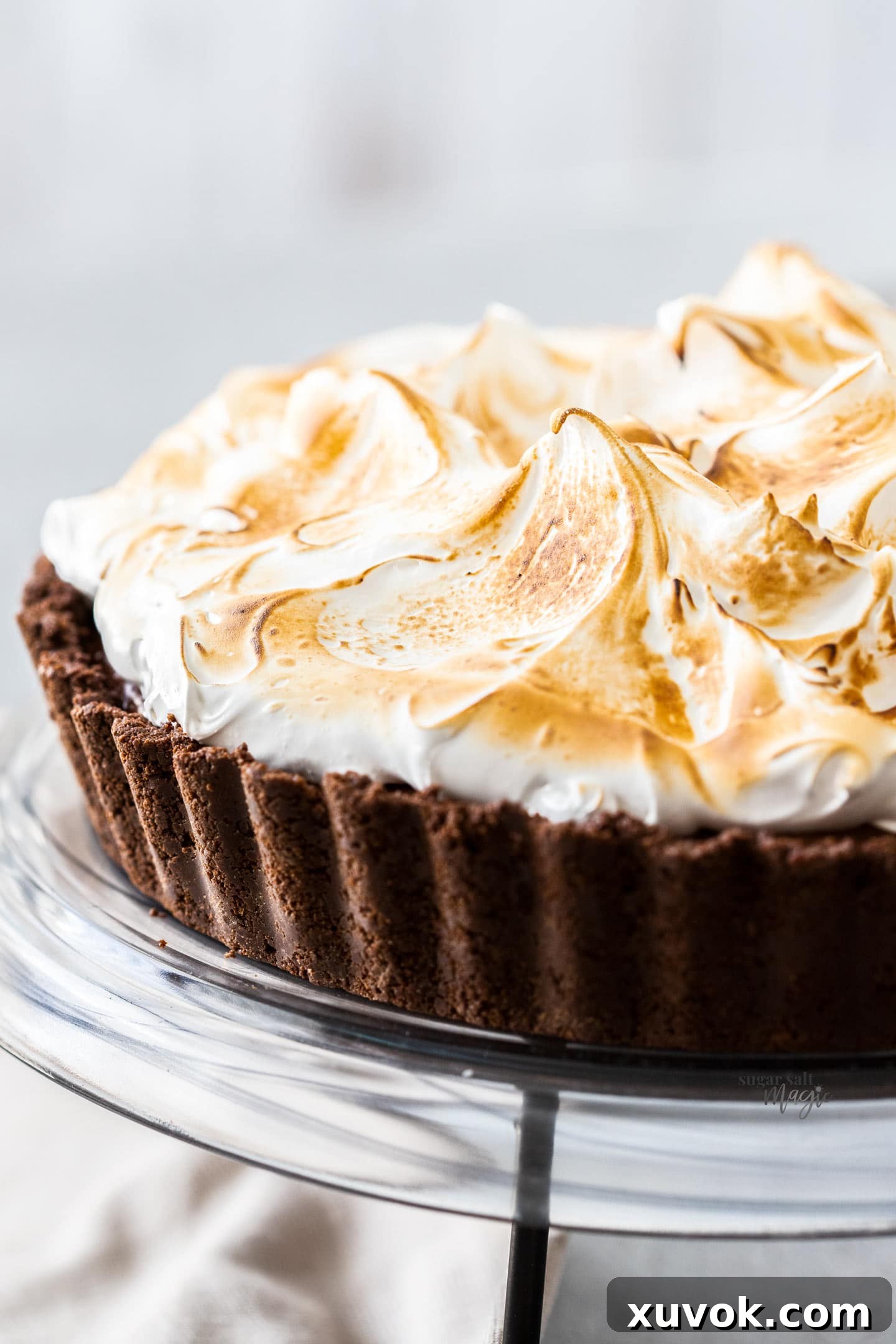 Closeup of a delectable no-bake chocolate meringue pie, showcasing its smooth chocolate filling and fluffy white topping.