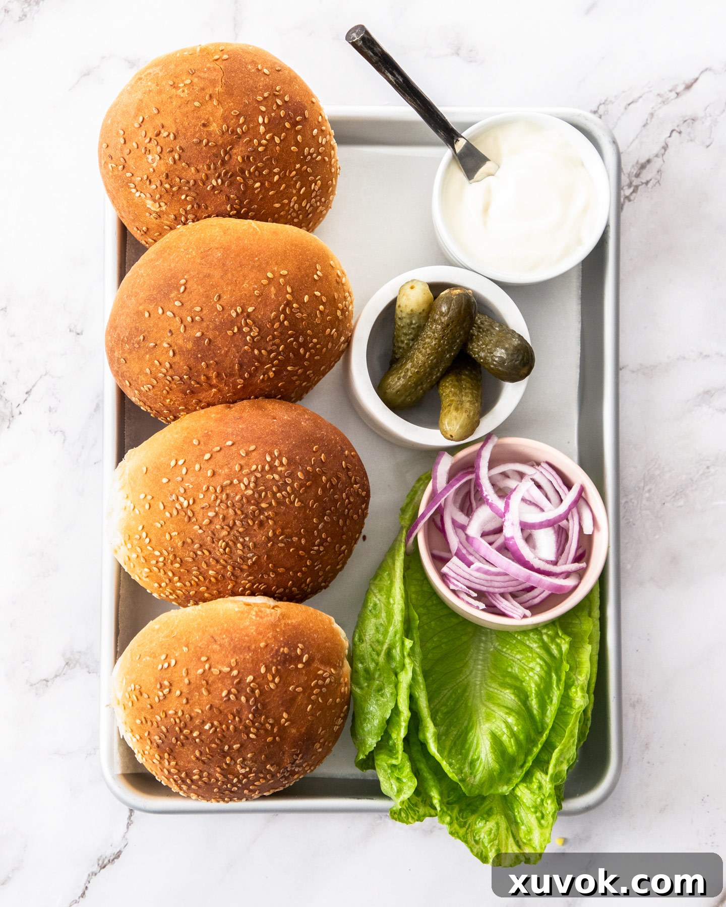 Buns and toppings for fried chicken burgers ready for assembly.
