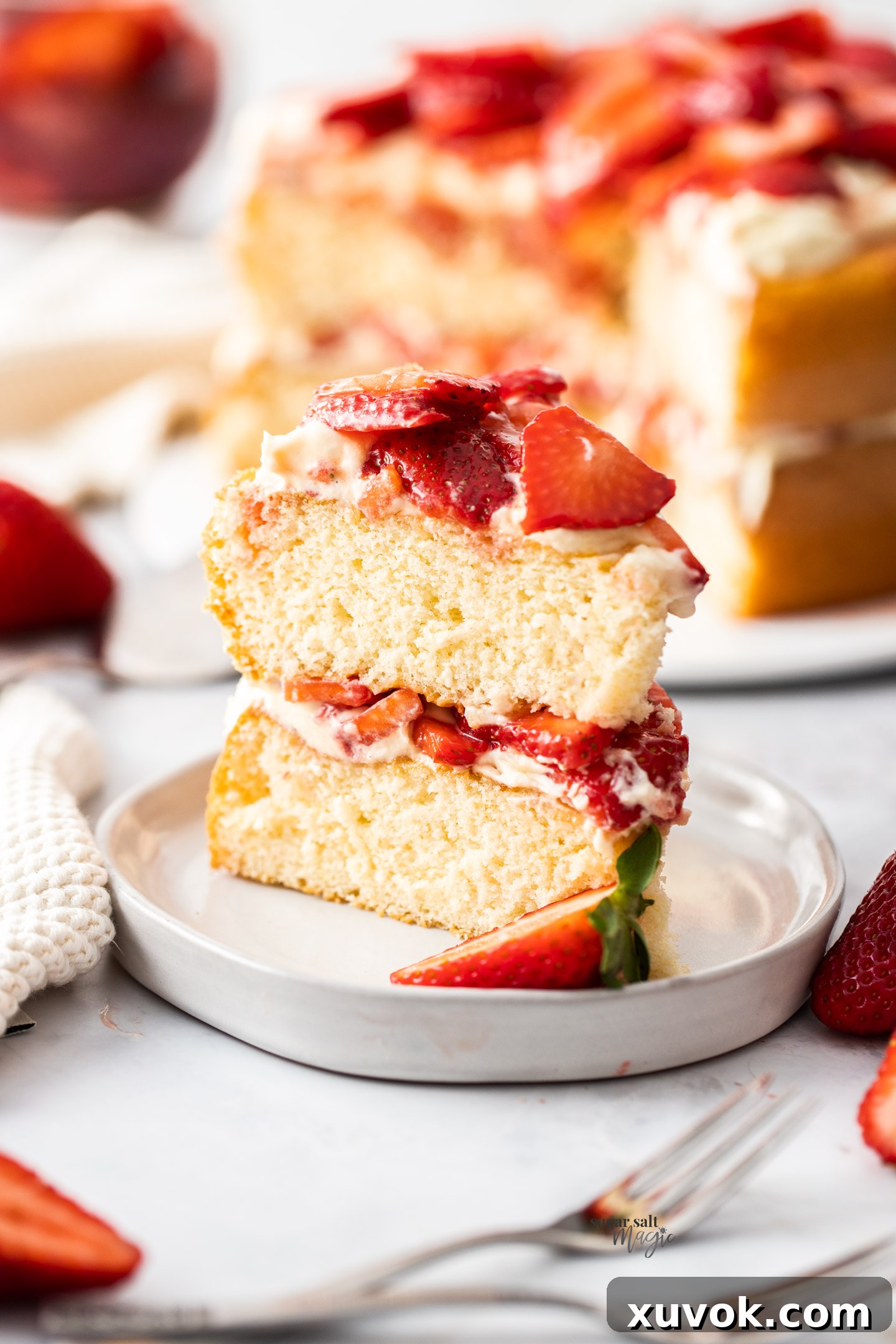 A delectable slice of strawberry sponge cake resting on a dessert plate, showcasing its layers.