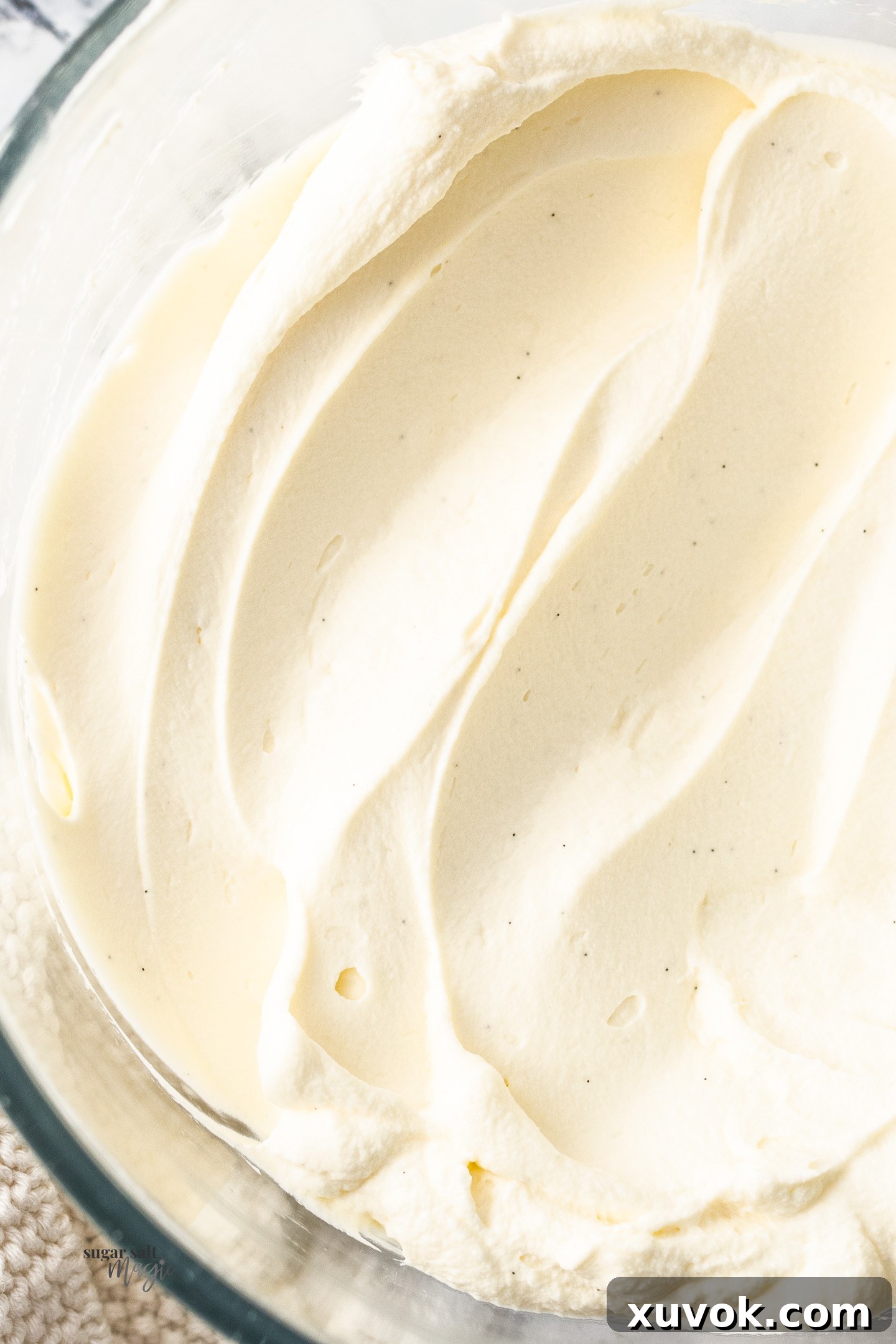 Closeup of chantilly cream in a bowl, showcasing its light and airy texture.