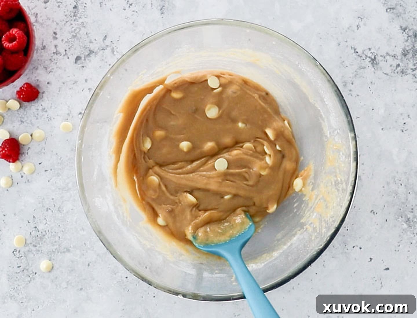 Blondie batter with white chocolate chips gently folded in, showcasing the perfect consistency before baking.