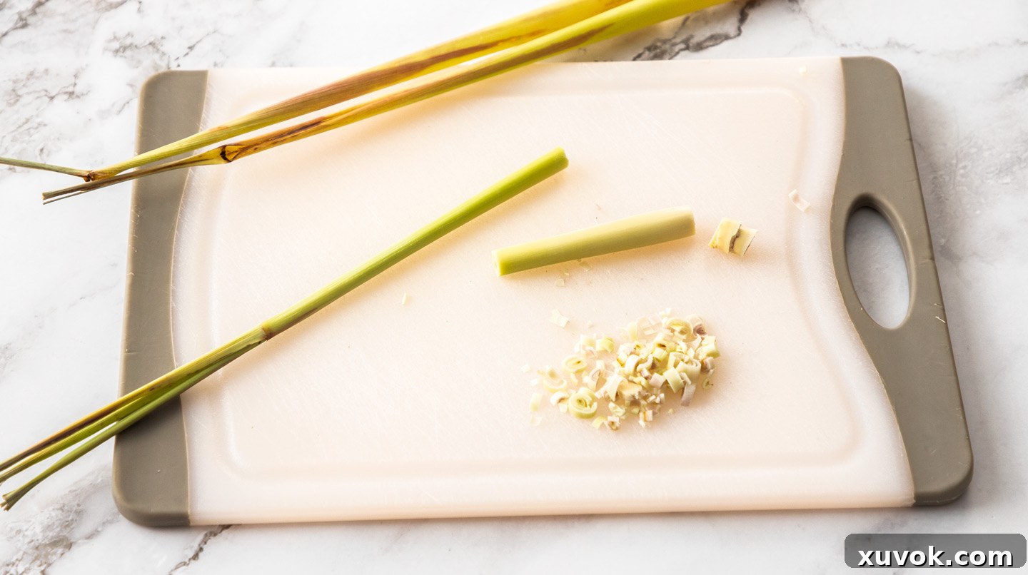 Fresh lemongrass stalks on a chopping board, highlighting the edible white portion.