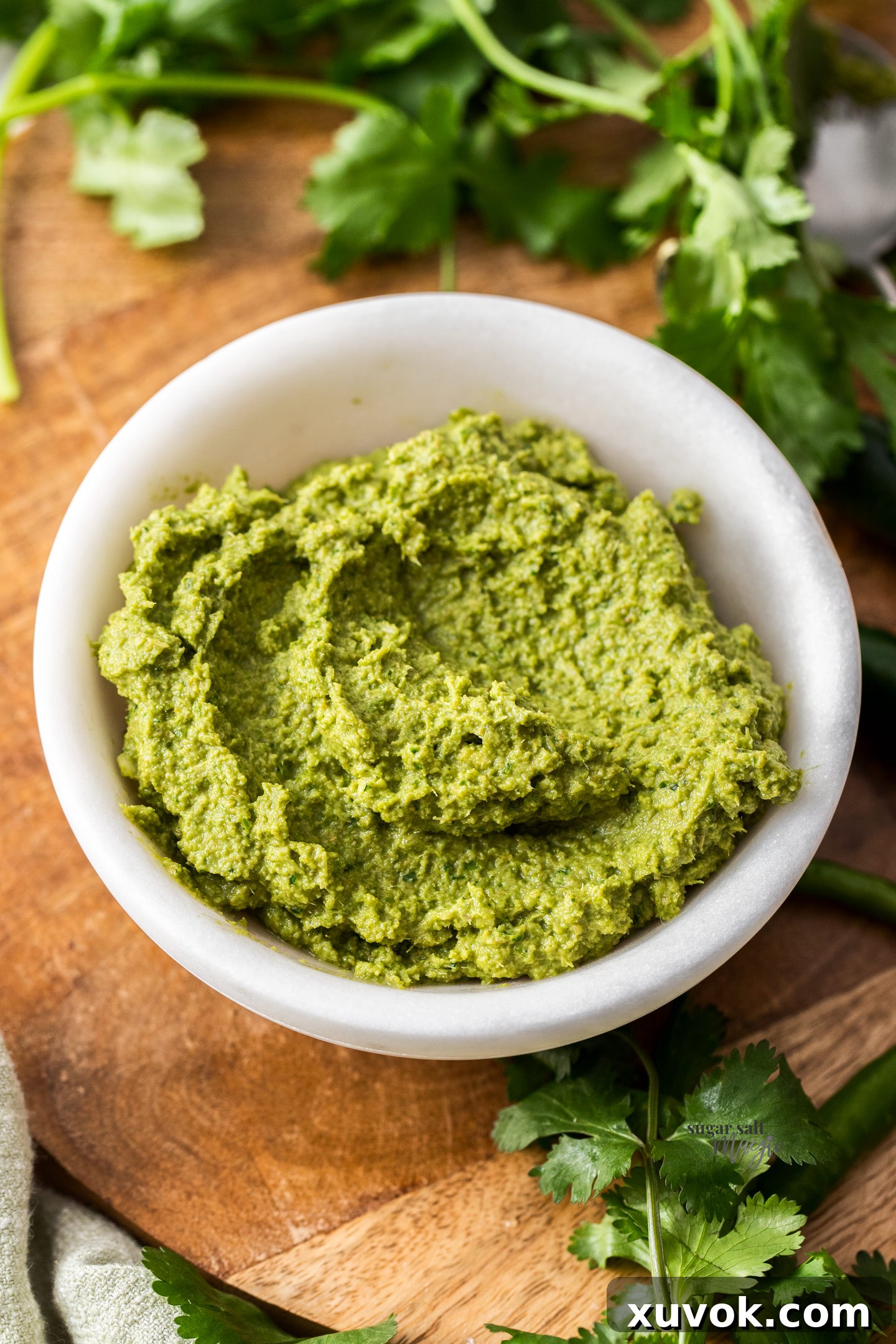 Creamy, vibrant homemade Thai green curry paste in a sleek marble bowl, ready for use.