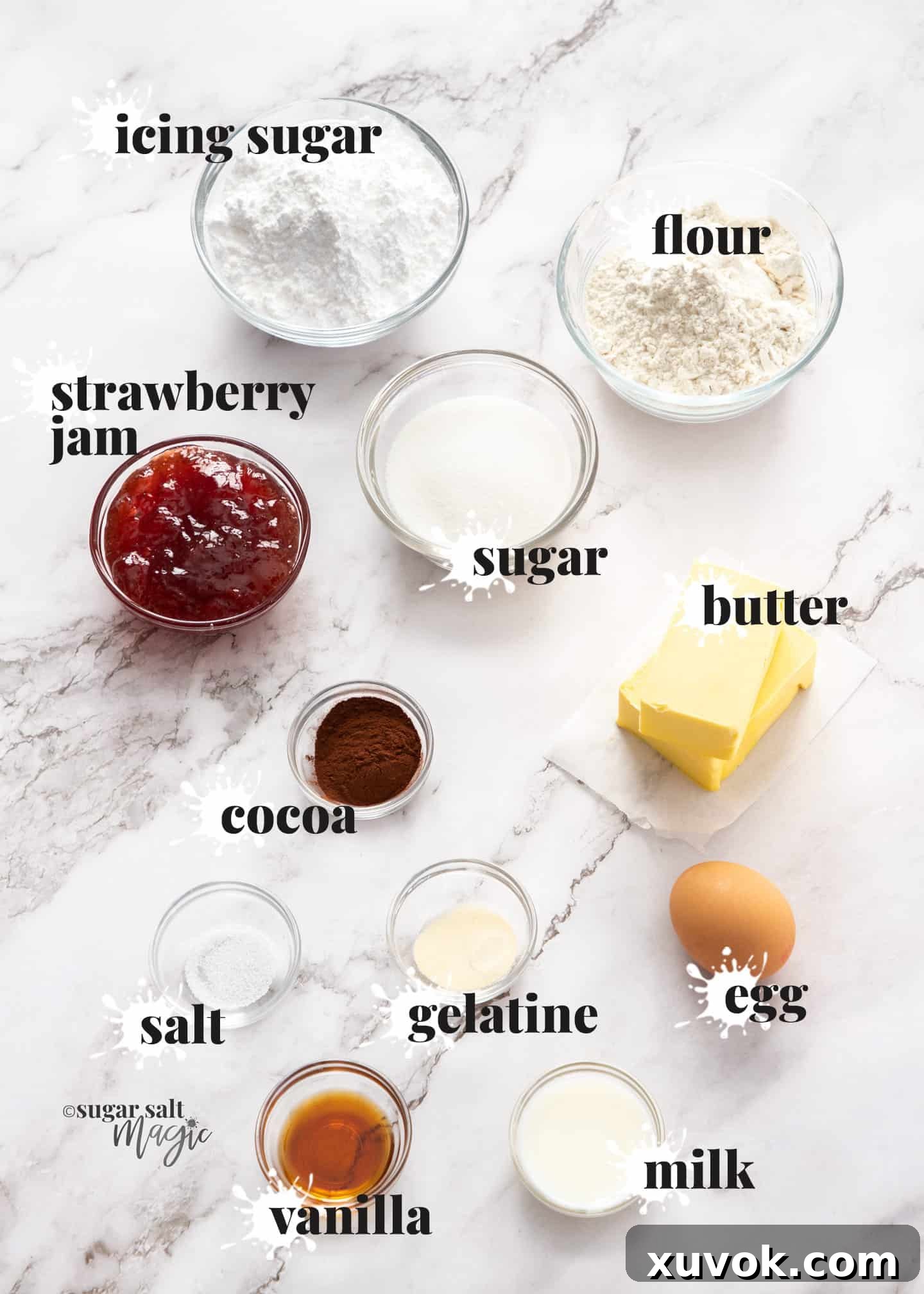 Various ingredients for Neenish tarts, including flour, butter, sugar, eggs, jam, and cocoa powder, neatly arranged on a white marble countertop, ready for preparation.