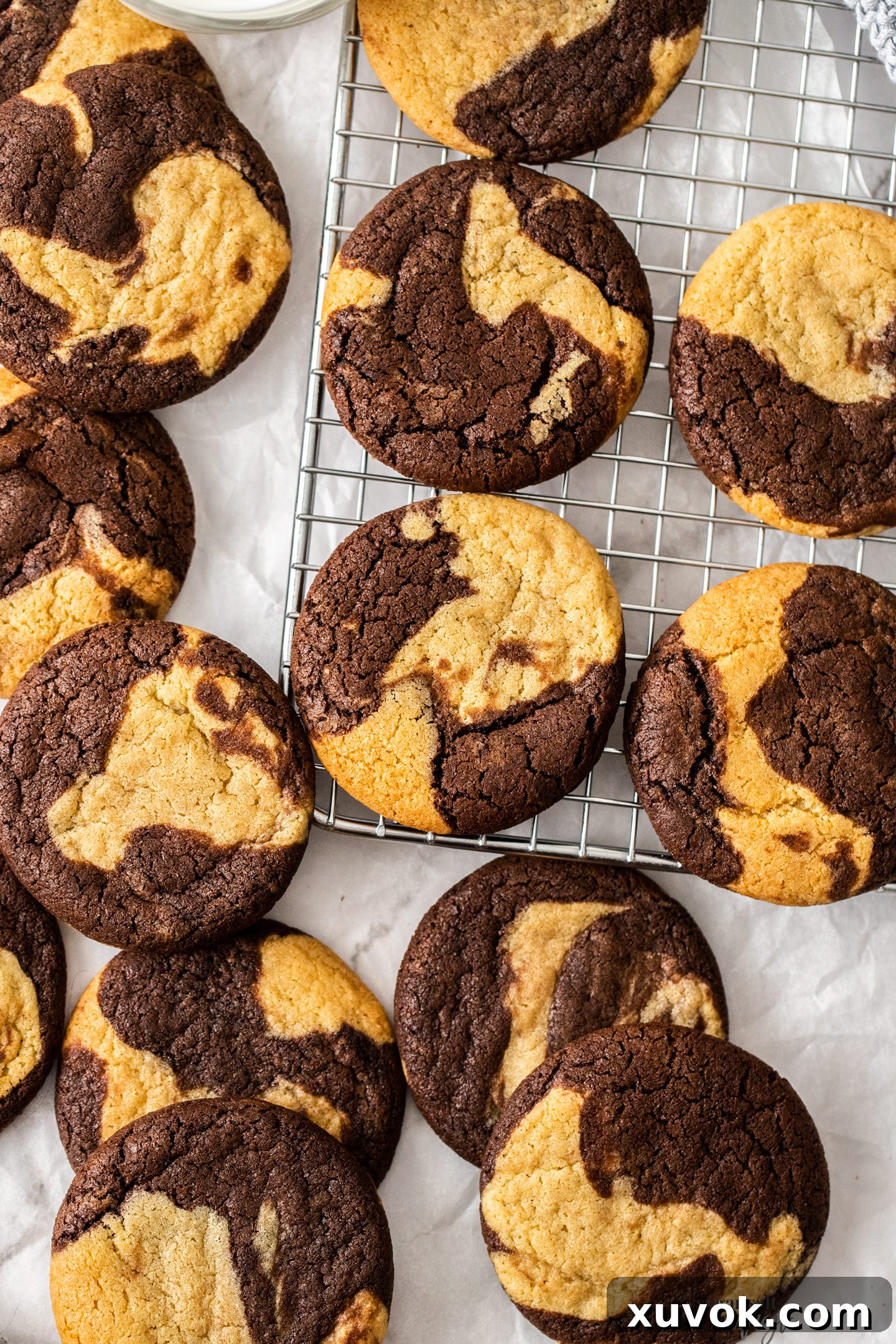 A fresh batch of marble cookies cooling on a wire rack.