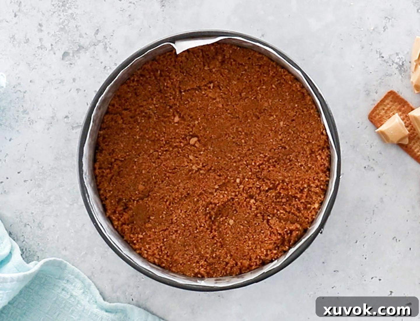 The golden-brown cookie base for the Caramilk cheesecake, perfectly pressed into a springform pan.