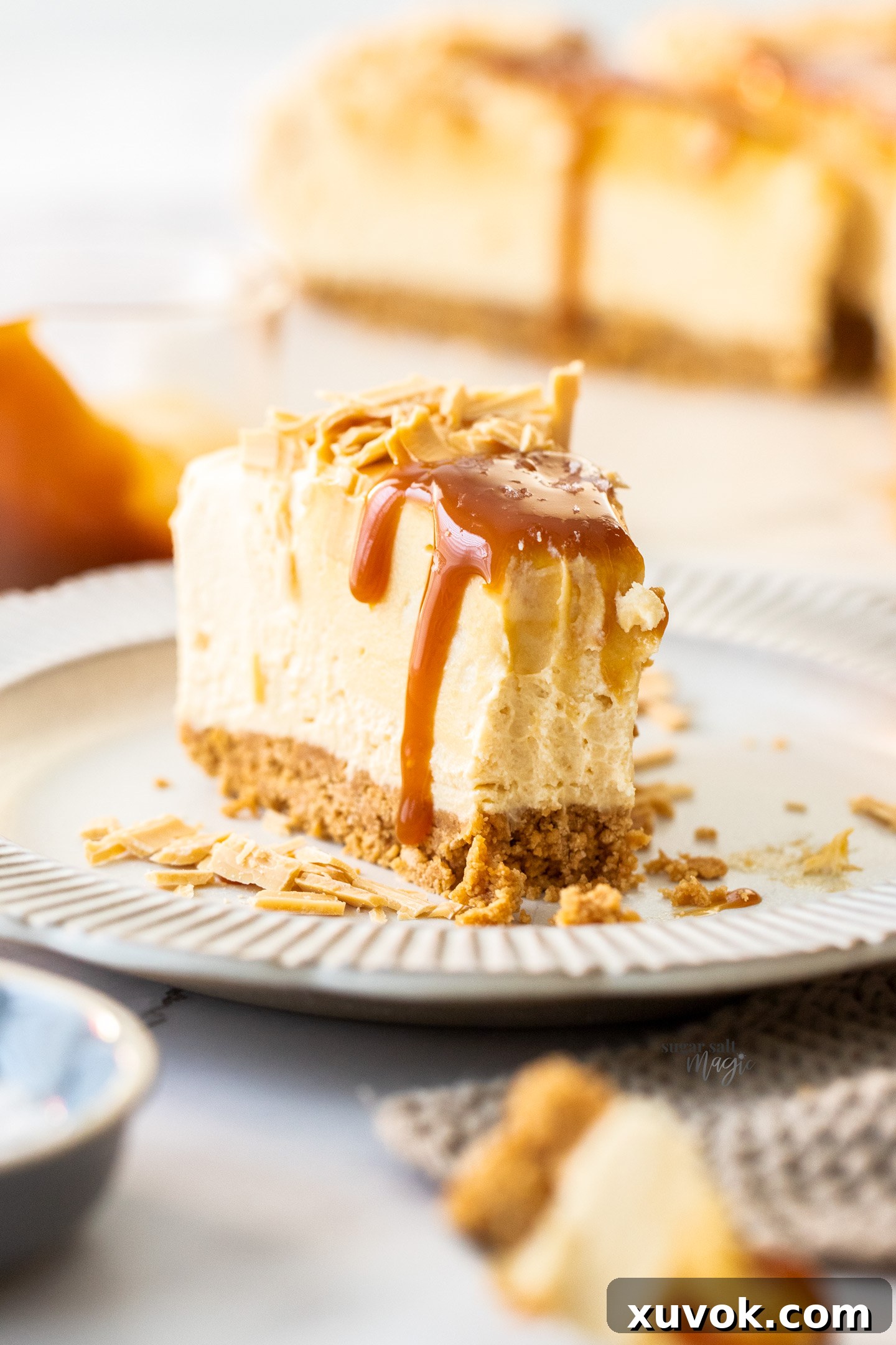 A close-up shot of a single slice of Caramilk cheesecake with a fork taking a bite, highlighting its creamy texture and deliciousness.