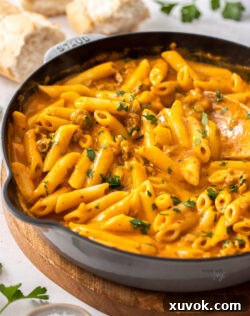 Penne pasta in a pumpkin sauce still in a skillet.