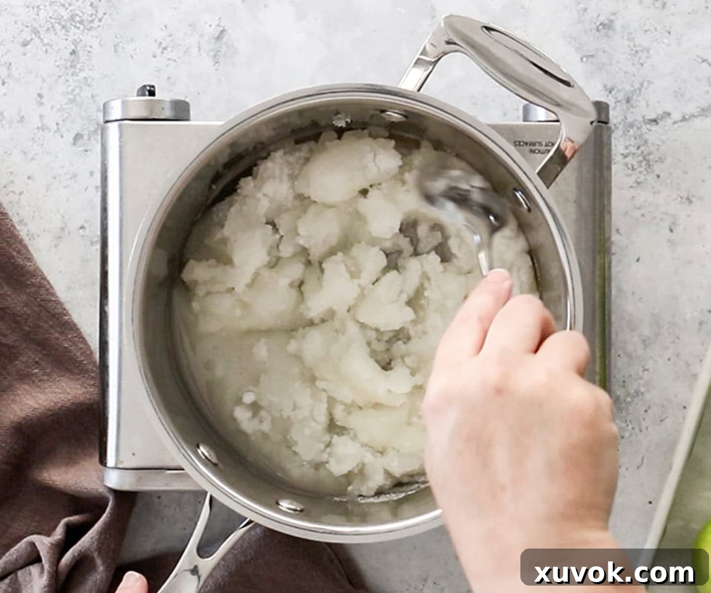 Dissoving sugar into water in a saucepan.
