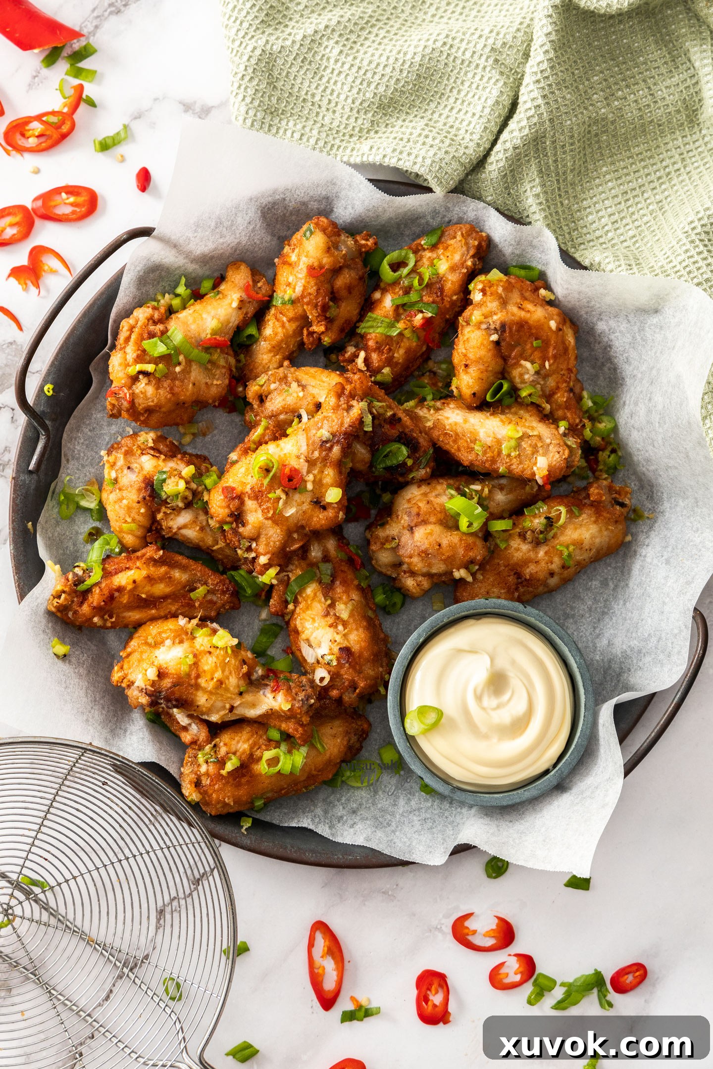 Top down view of chinese salt and pepper wings on a metal tray.