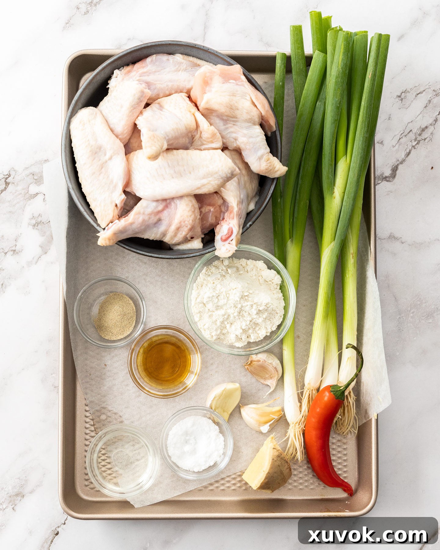 Ingredients for salt and pepper wings on a baking tray.