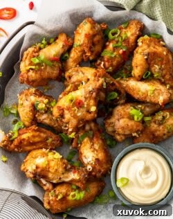 A batch of salt and pepper wings on a metal tray with Kewpie mayonnaise.