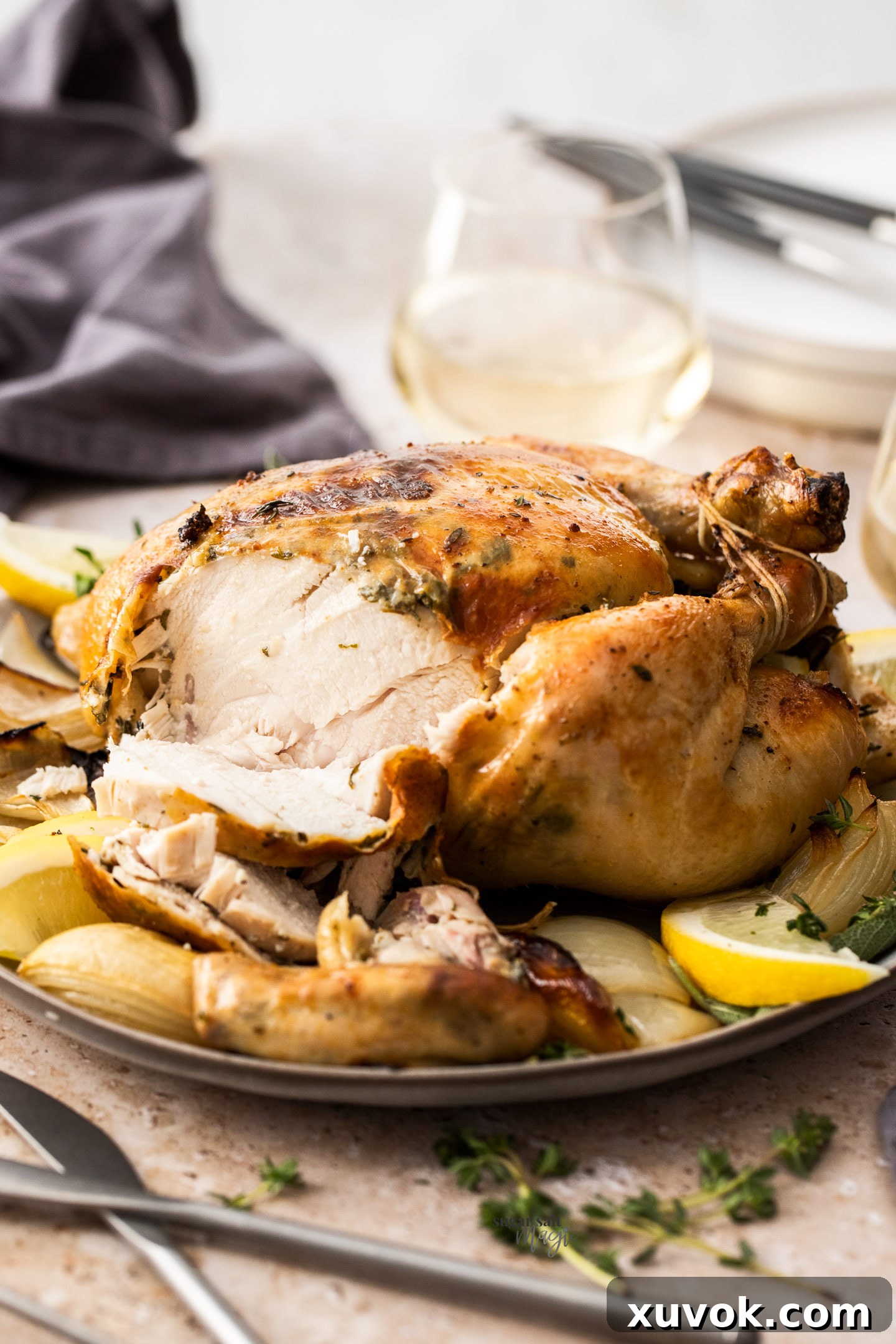 A whole roasted chicken that has been carved, showcasing its golden skin and juicy interior.