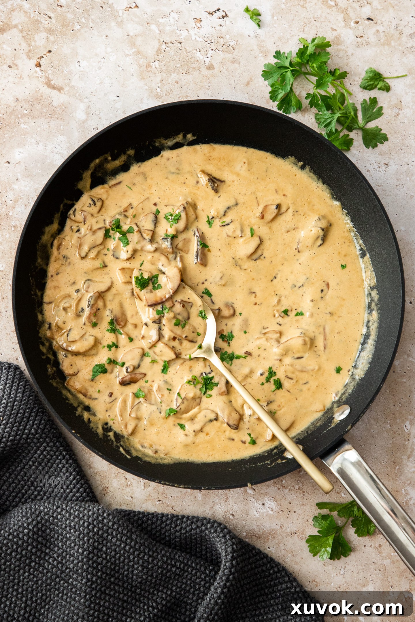 Top-down view of the creamy mushroom sauce simmering in a skillet, showcasing its rich texture and color.