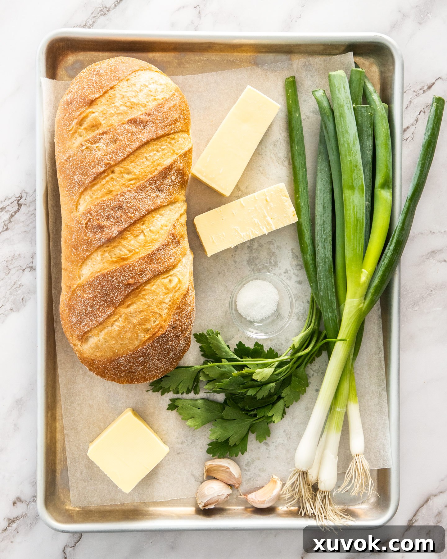 Ingredients for cheese and garlic crack bread on a baking tray.