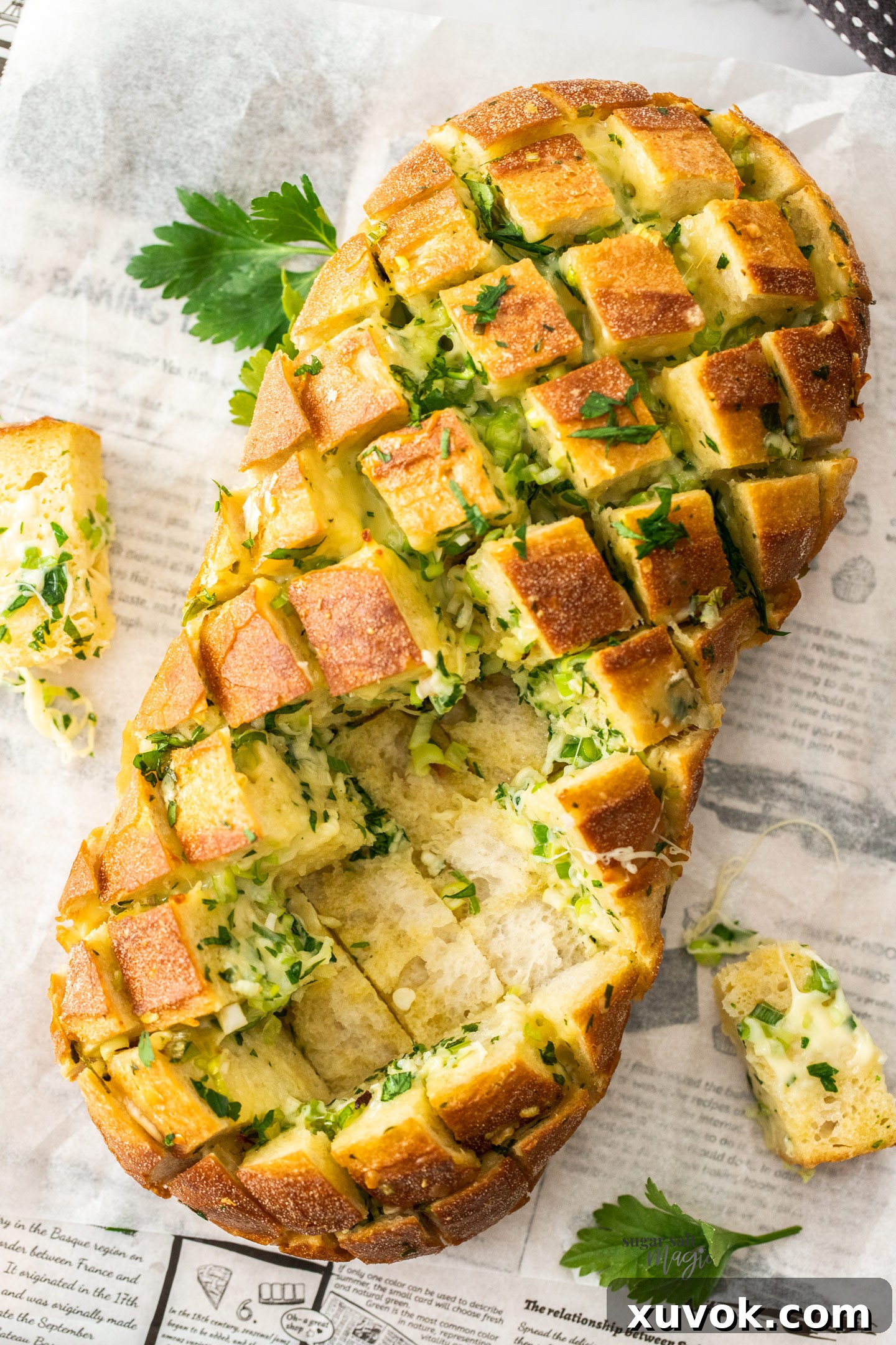 Top down view of garlic crack bread with some missing.