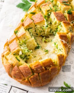A loaf of bread cut into cubes with some removed.
