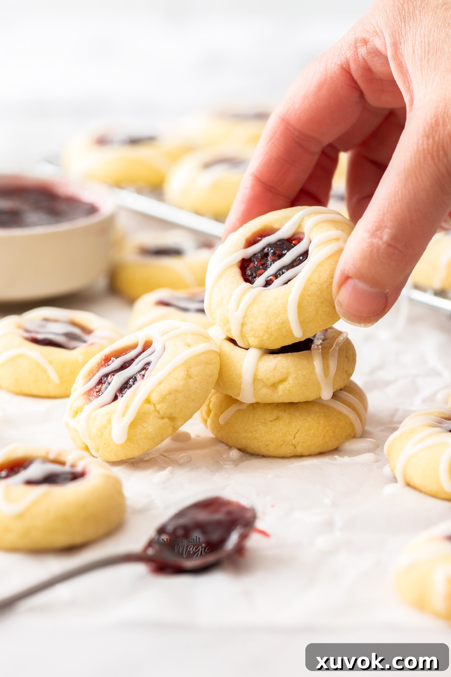A hand picking up a cookie.
