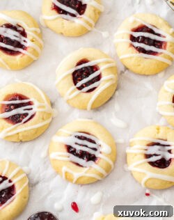 Closeup of 9 jam thumbprint cookies.
