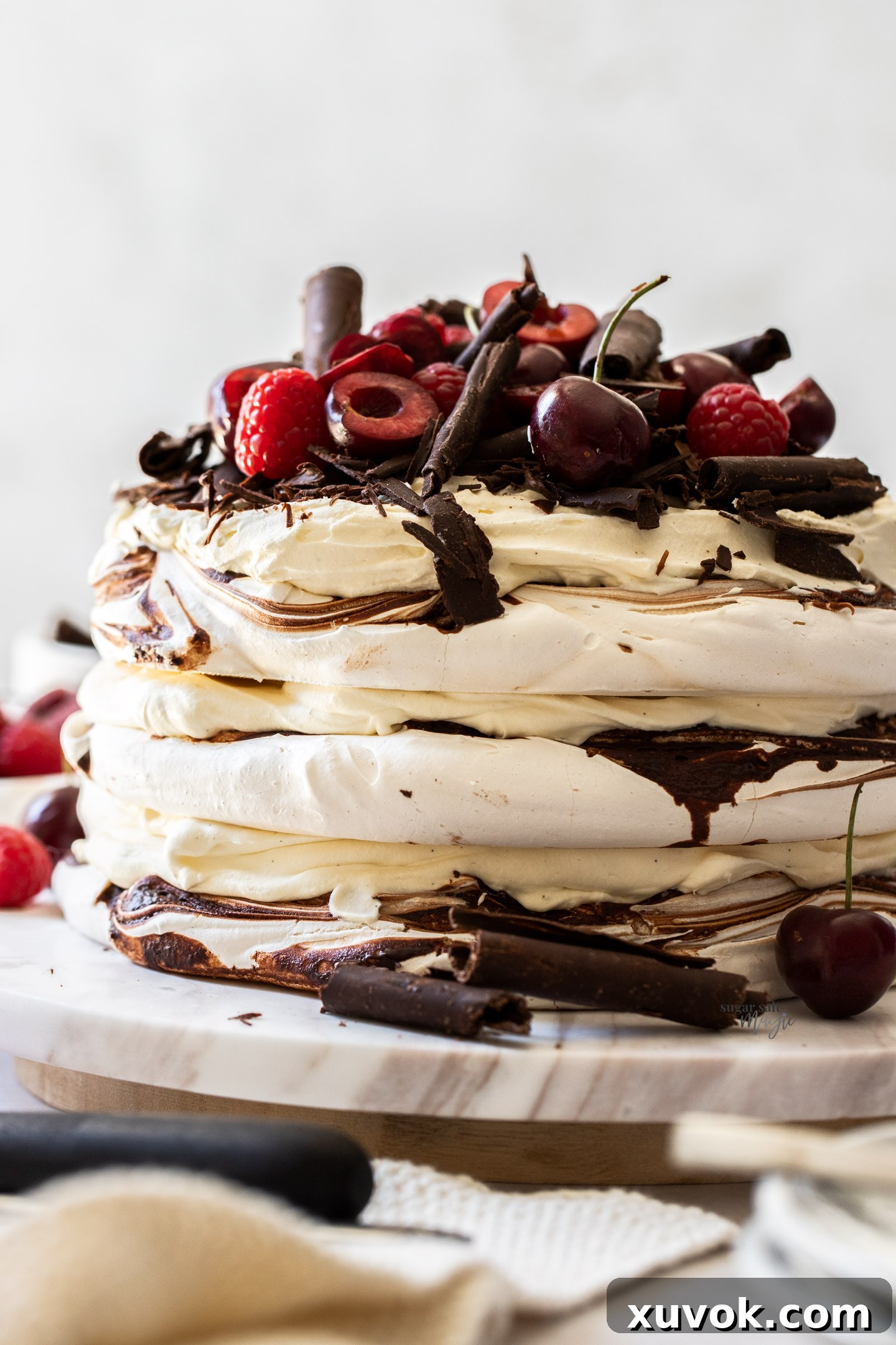 A 3 layered meringue cake with cream between the meringue layers.