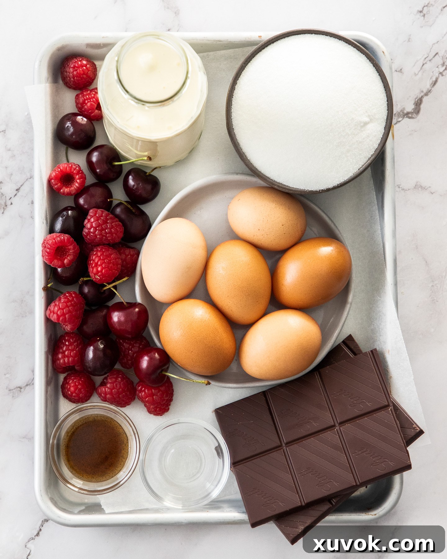 Ingredients for chocolate meringue cake on a baking tray.