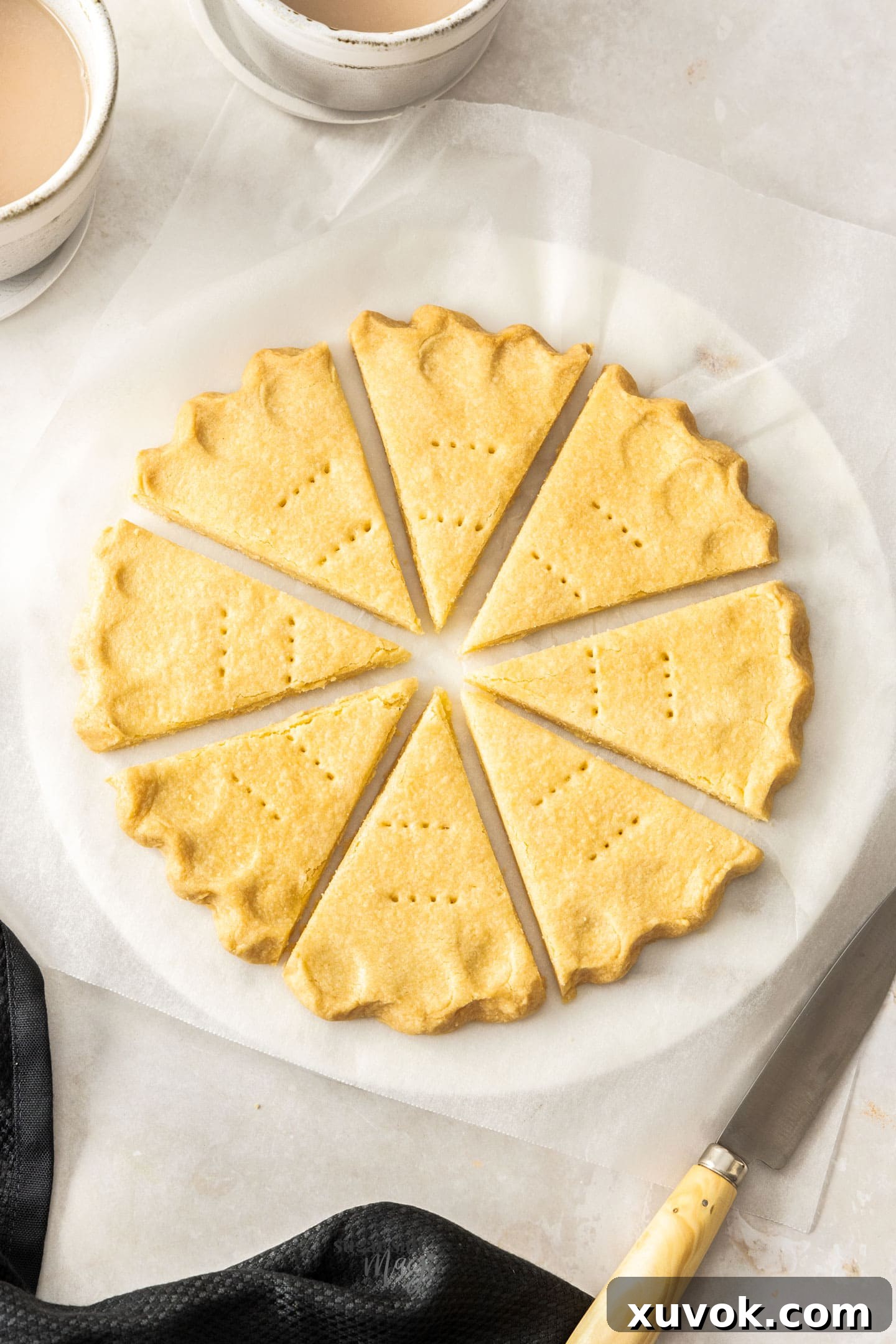 Top-down view of beautifully arranged all-butter shortbread petticoat tails, highlighting their classic shape and golden hue.