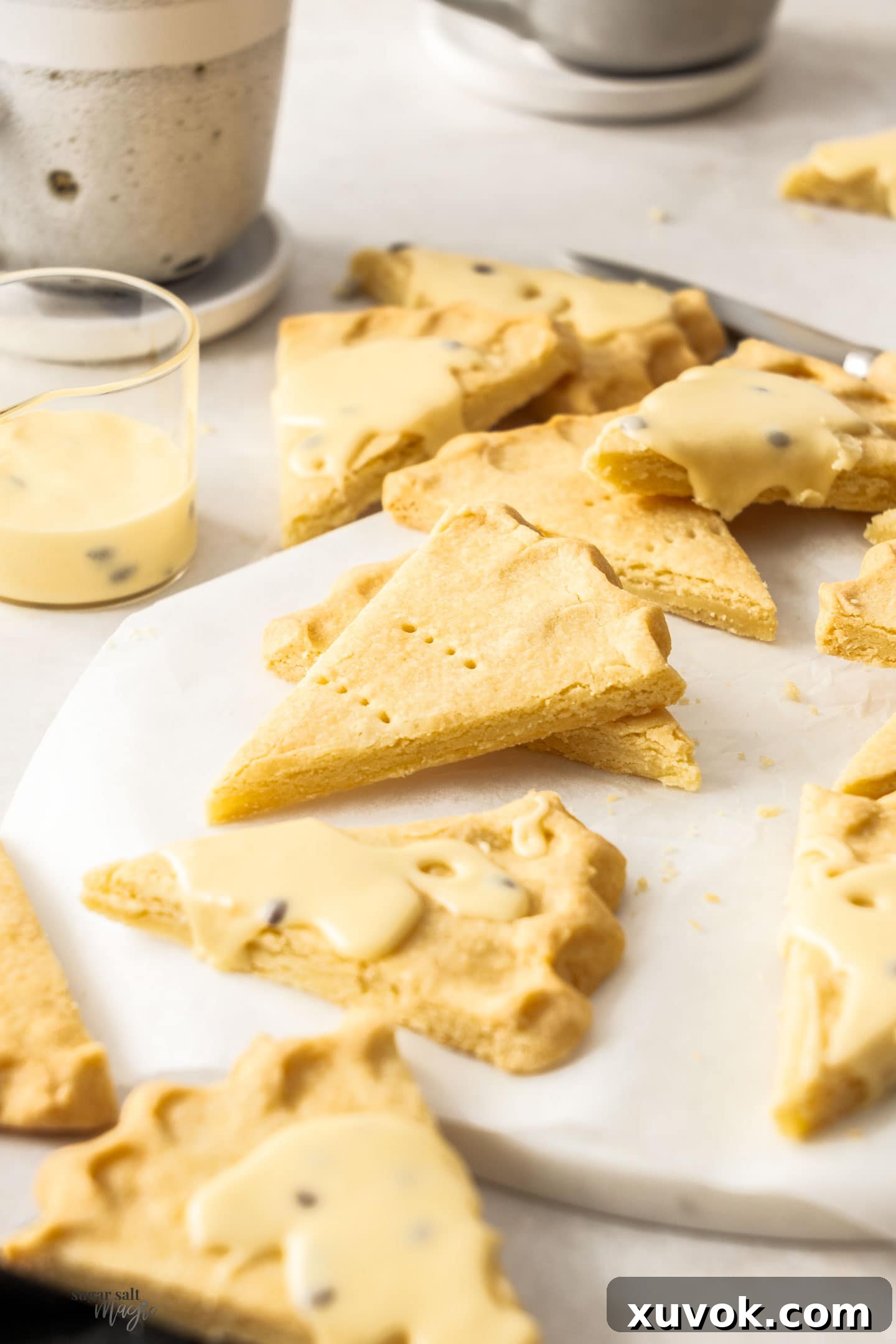 Numerous shortbread wedges artfully arranged on an elegant marble platter.