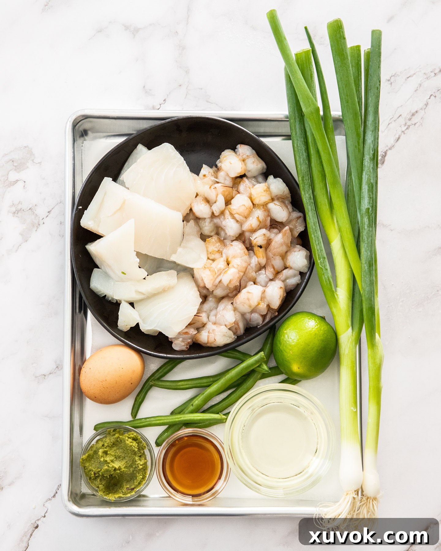 Ingredients for Thai fish cakes on a baking tray.