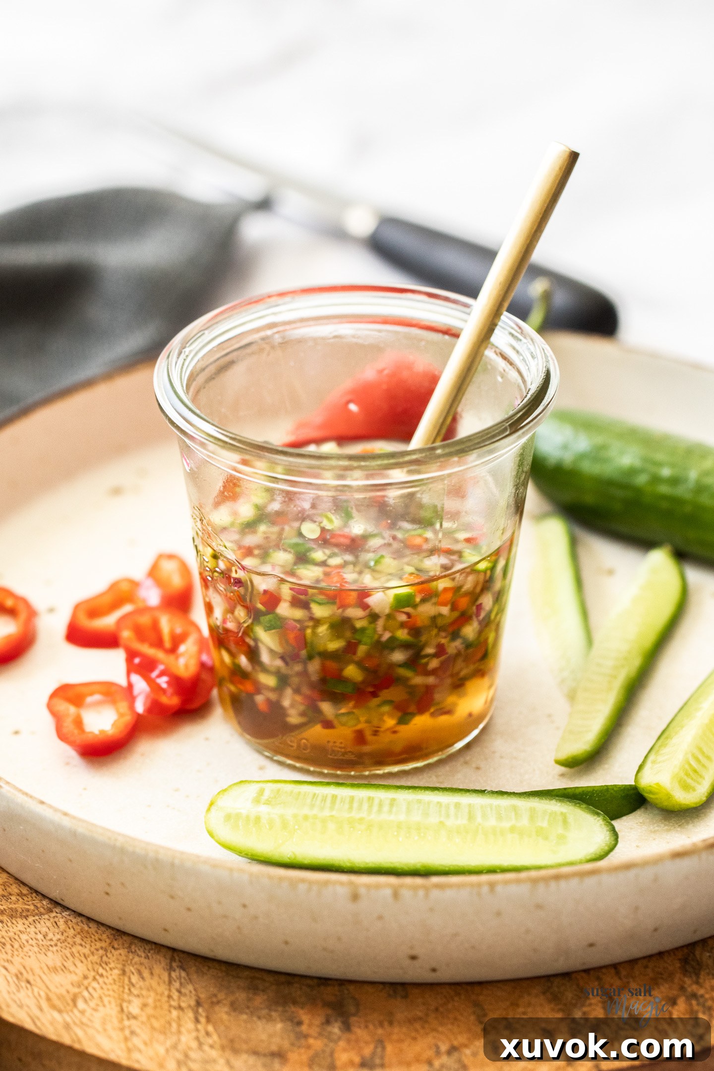 A jar half filled with Thai cucumber relish.