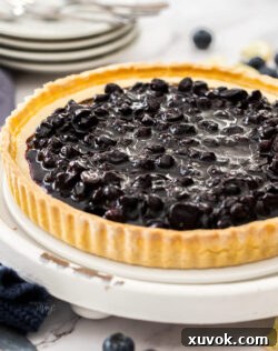Closeup of the blueberry compote on the tart, highlighting its rich color and texture.
