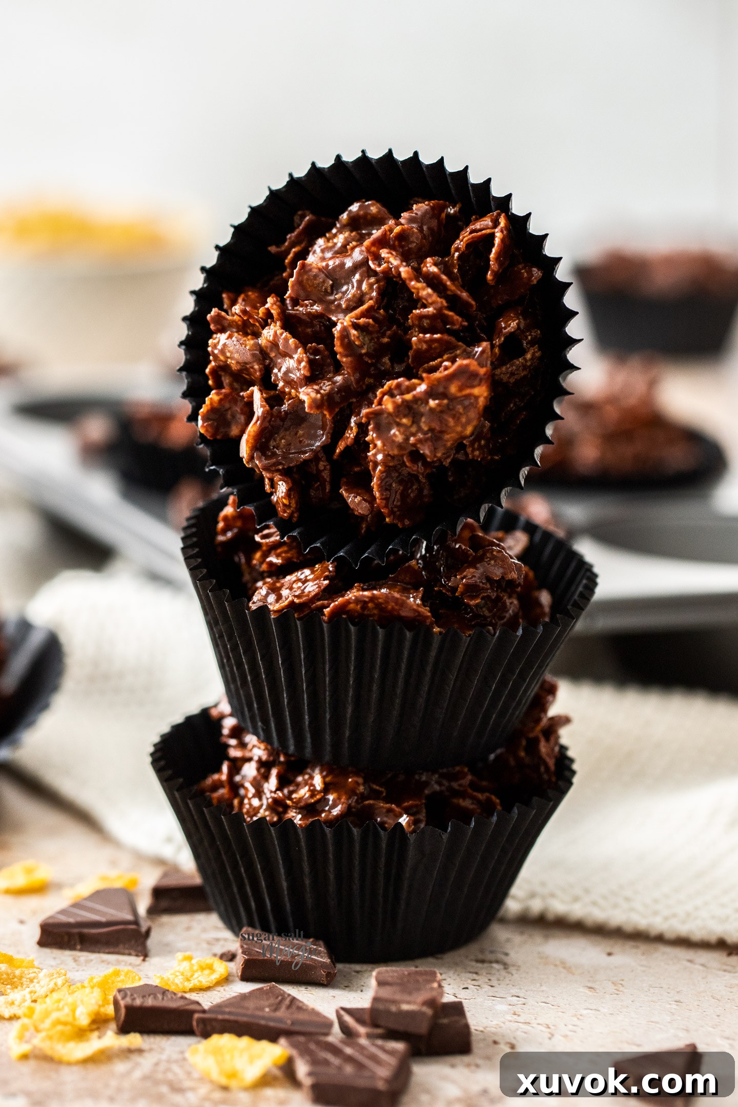 A stack of 3 chocolate cornflake cakes.